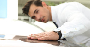 Salesman consulting young couple in car salon